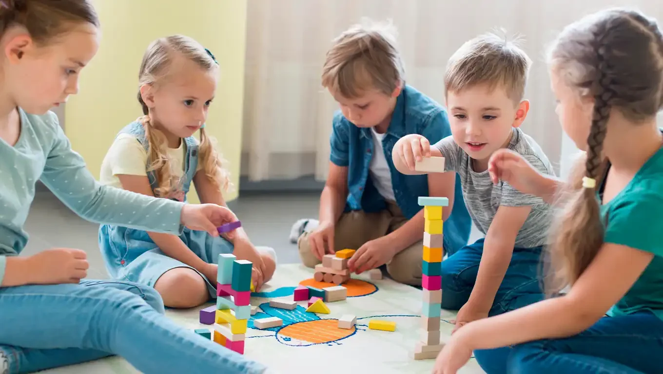 Navigating the Confusing World of Behavioral Health Levels of Care 10 A group of young children playing together with colorful building blocks