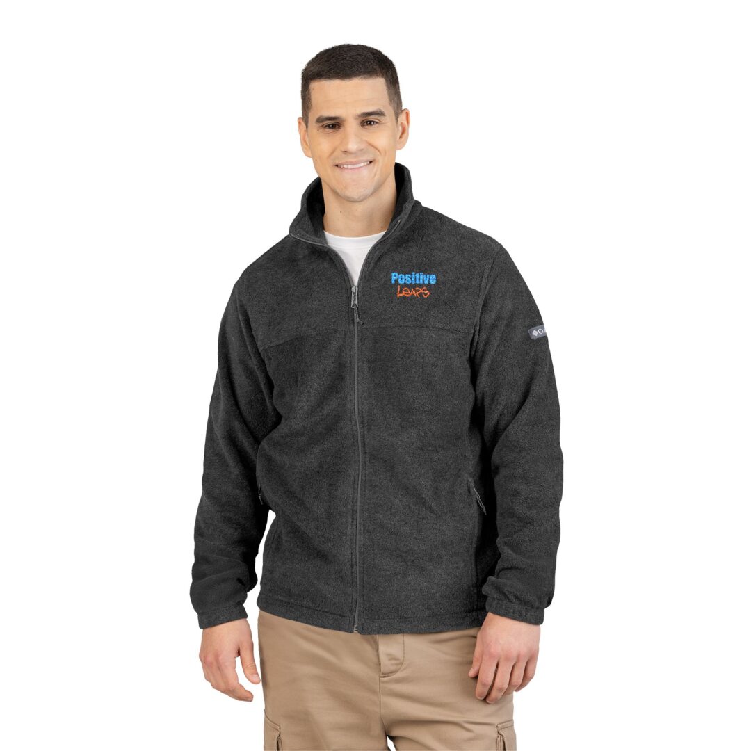 Embroidered Unisex Fleece Jacket - Cozy Columbia Outerwear 4 A person models a charcoal grey zip-up fleece jacket embroidered with the Positive Leaps logo.