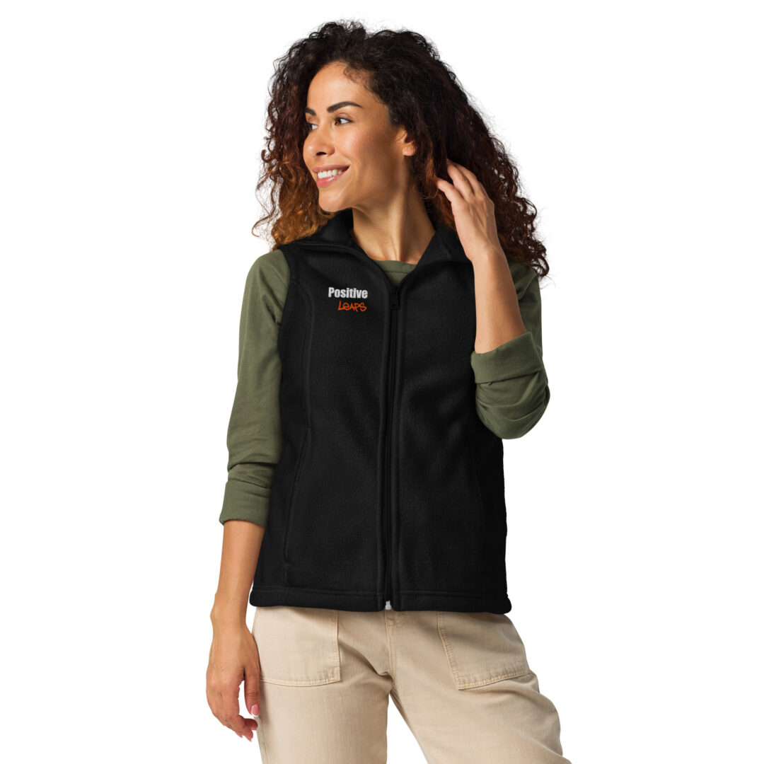 Positive Leaps Women’s Columbia fleece vest 1 A person models a professional black fleece vest, showing the Positive Leaps logo embroidered on the chest.