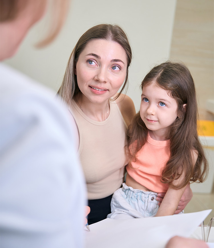 A mother and young daughter attending a pediatric behavioral health consultation and intake assessment.